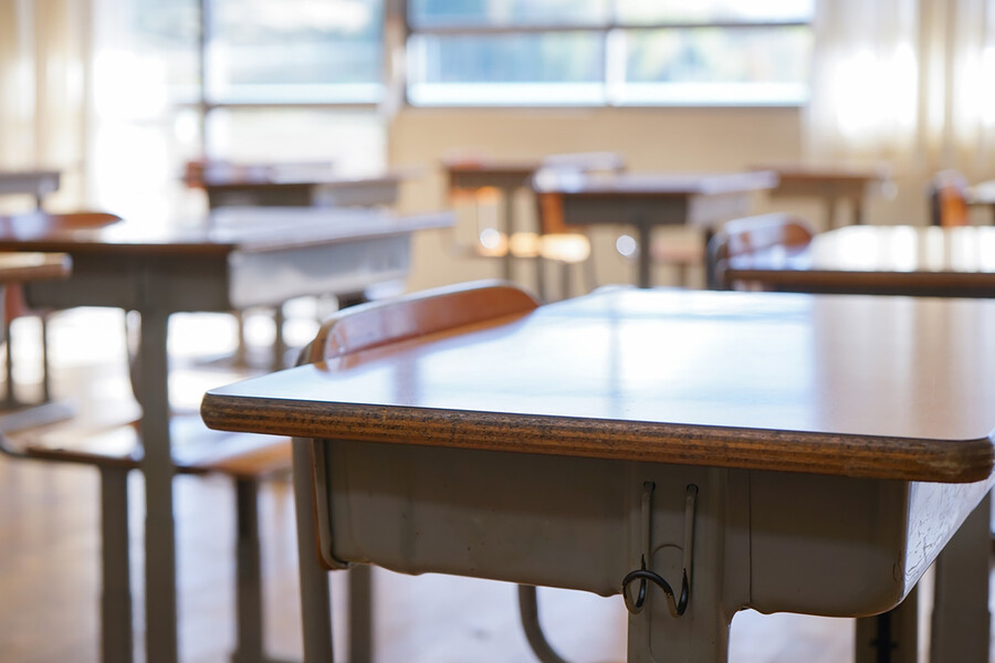 Empty desks in elementary school classroom.