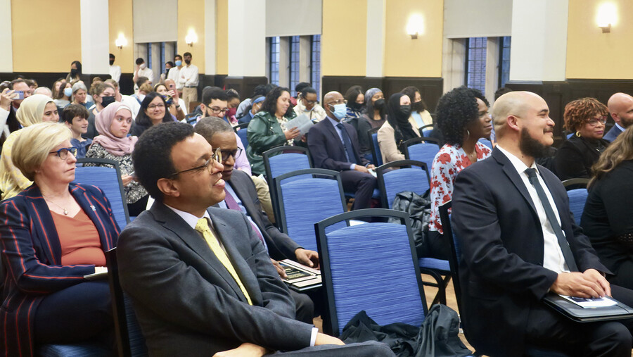 Members of the crowd seated in Bodek Lounge listening to a speaker.