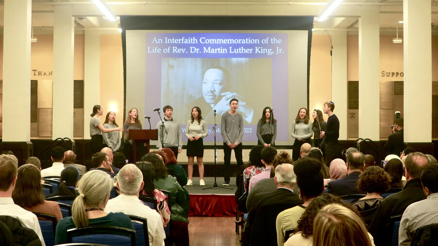 Members of the Jewish a cappella group Penn Shabbattones sing on stage.