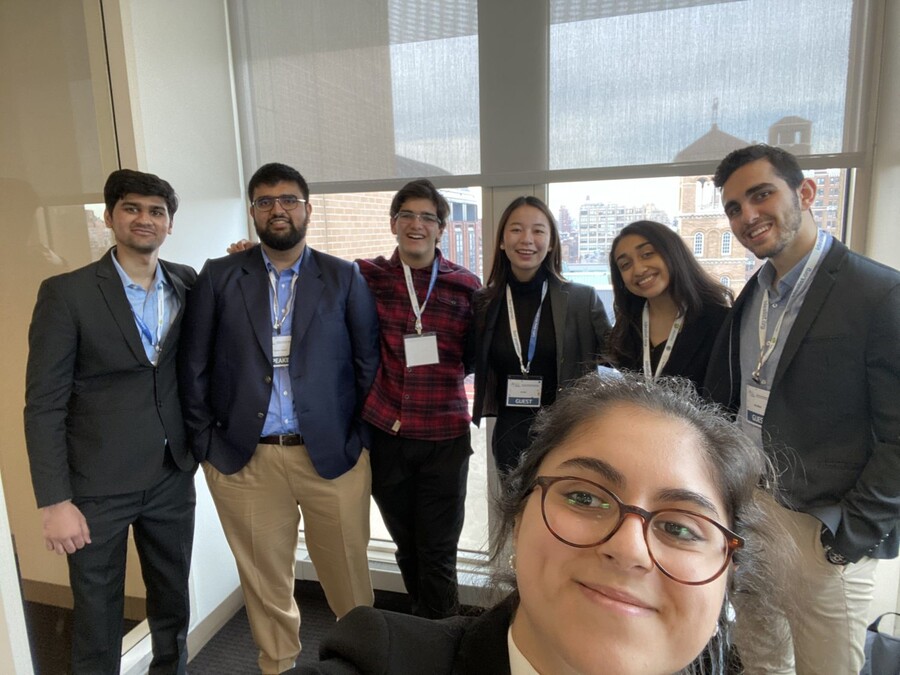 A selfie taken at the assembly with one person in the front and 6 other members in the back.