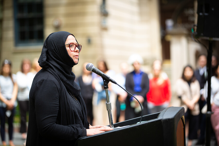 Person speaking at a podium at Penn’s gun violence vigil.