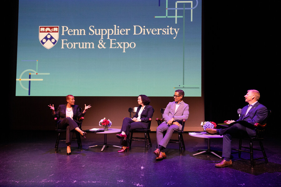 People sitting in a discussion on stage.