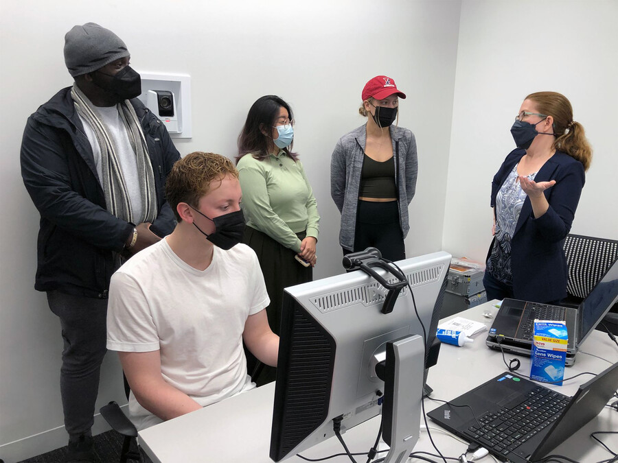 Four students and Elizabeth Johnson in a Wharton lab.