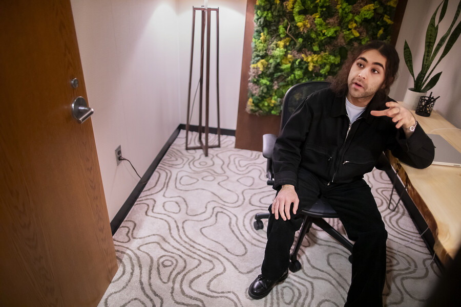 Farhan Jivraj sits at a desk in the biophilic room.