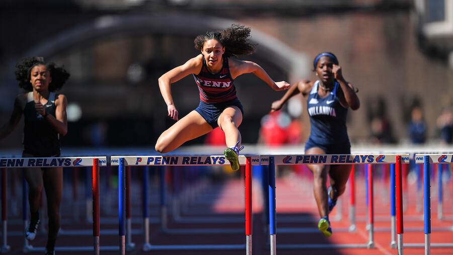 Skyla Wilson jumps over a hurdle.