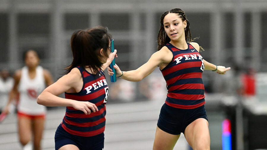 Skyla Wilson takes the baton from a teammate.
