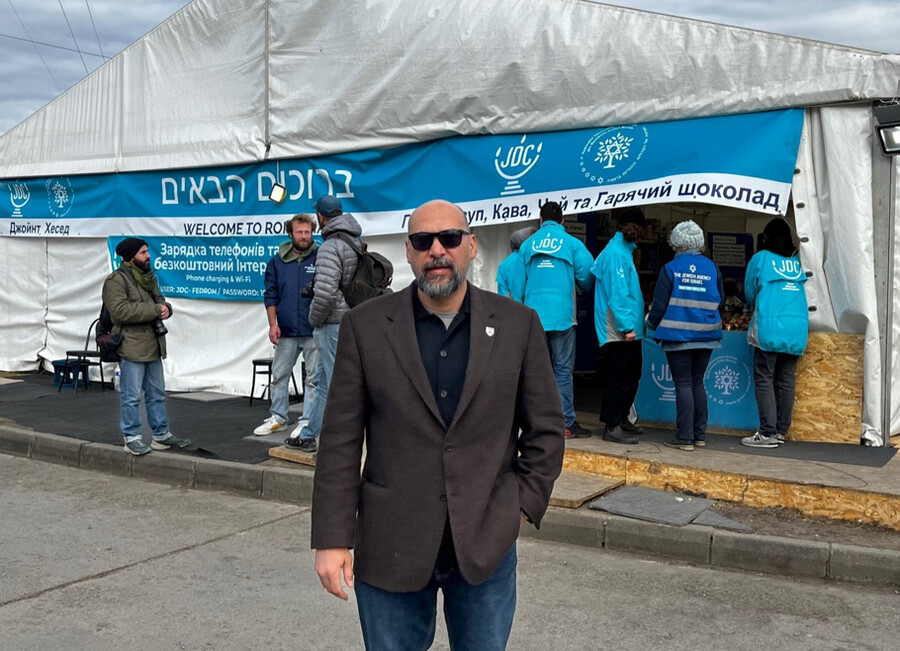 Kevin Sowti stands in front of an aid tent.