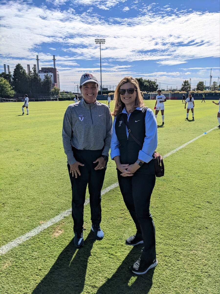 Krissy Turner (left), the Douglas N. Brush Head Coach, and Penn President Liz Magill converse before the game.