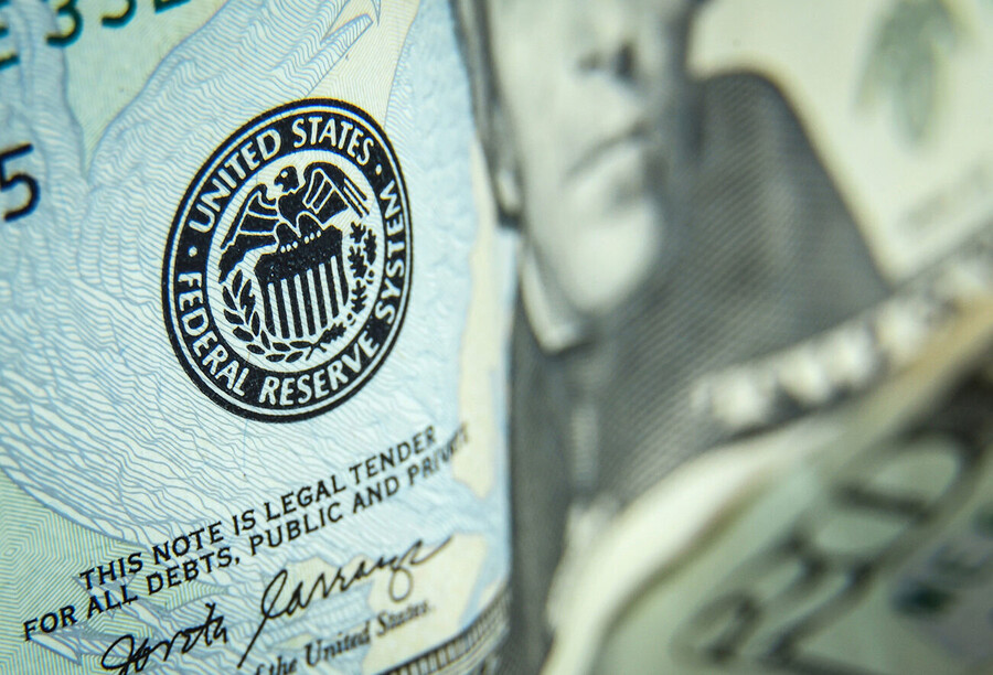 Closeup of a twenty dollar bill with the Federal Reserve System stamp highlighted.