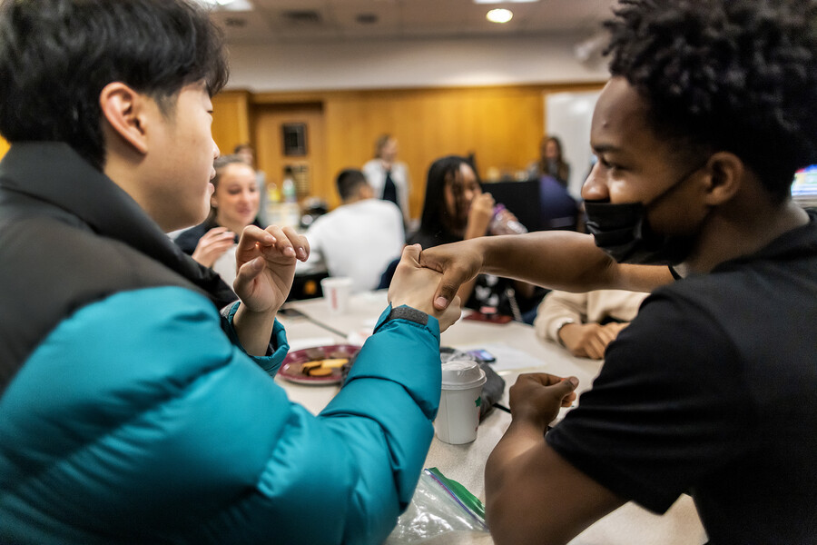 Penn Student Eric Yang shakes hands with Robeson High School Student Jayden Thompson