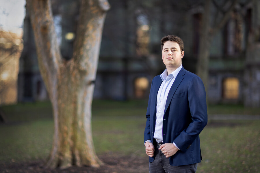 Maksym Potlov stands in front of College Hall on Penn campus.