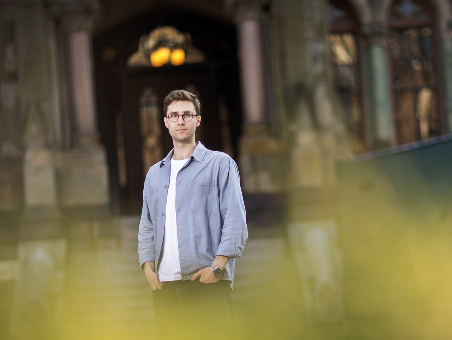 Serhii Shadrin poses in front of College Hall on Penn campus.