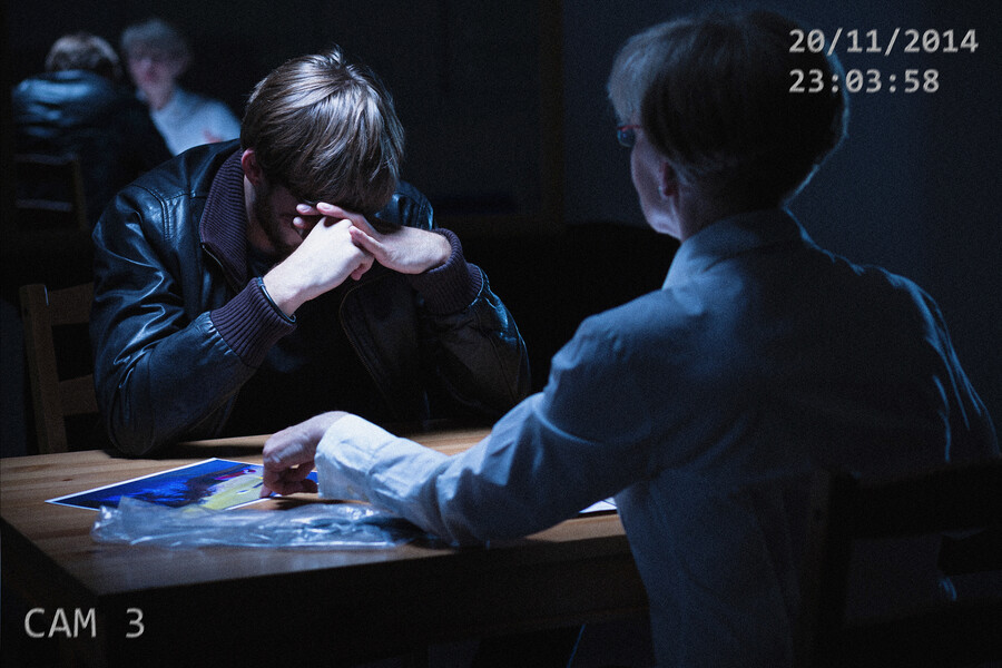Video still of a police interrogation.