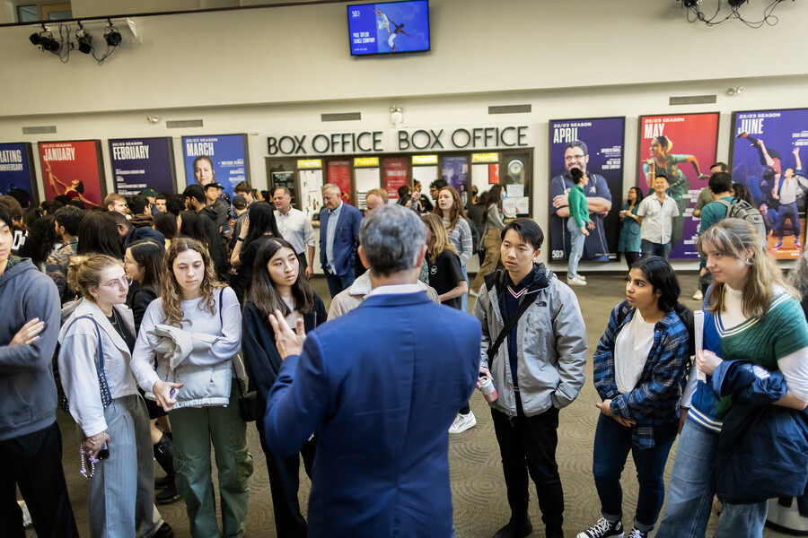 Christopher Tucker talking with attendees in the lobby at the Annenberg Center