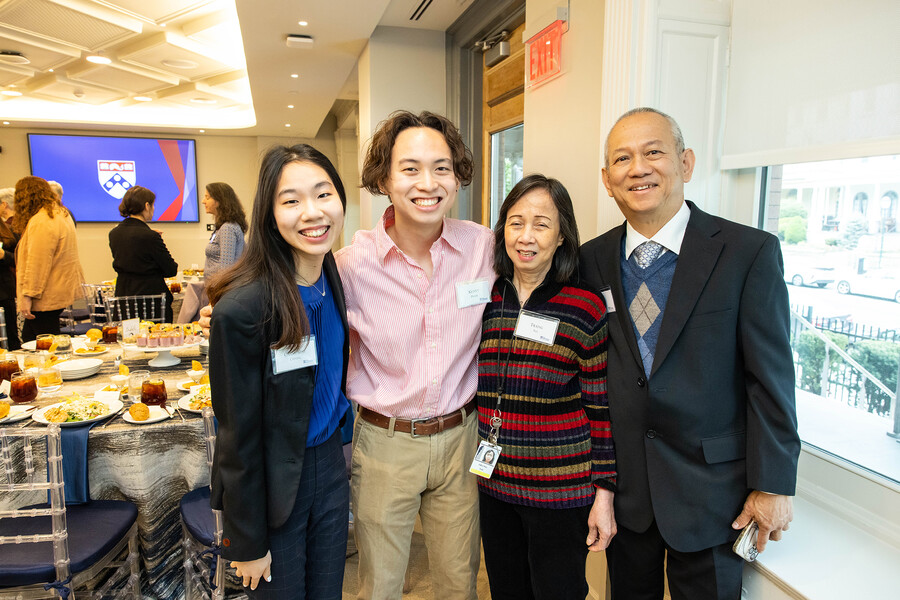 Chang, Pham, and Pham's parents smile for a photo