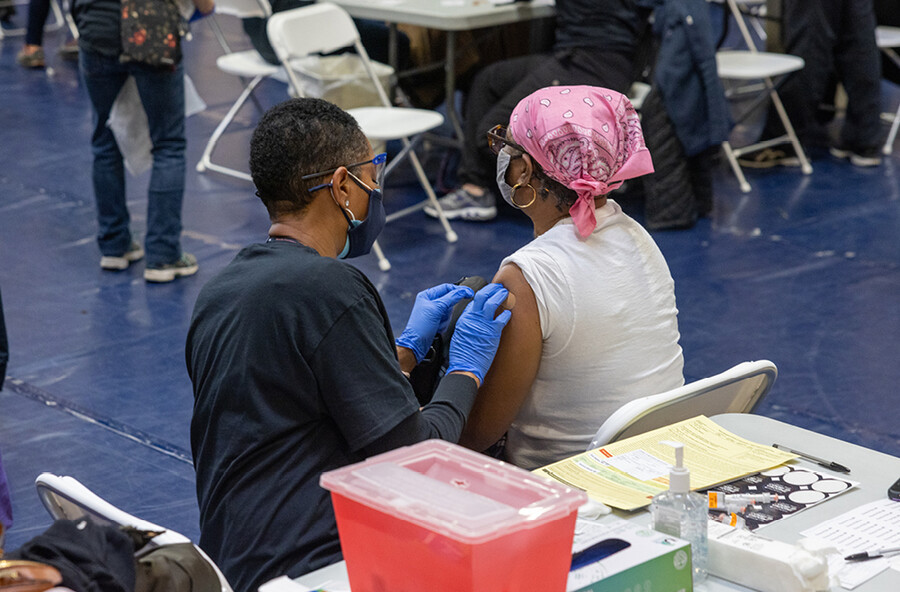 A medical worker gives a person a Covid vaccine.