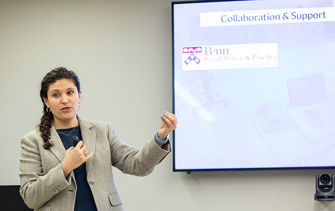 Millan AbiNader presenting next to a screen.