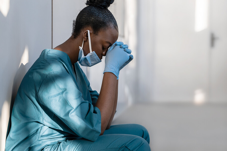 Exhausted nurse resting their head.
