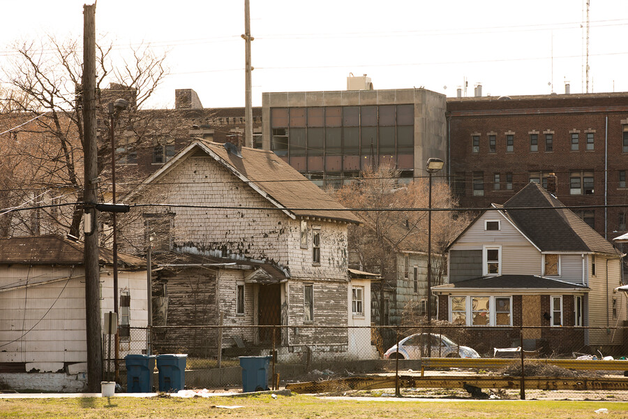 A crumbling house in an impoverished neighborhood.