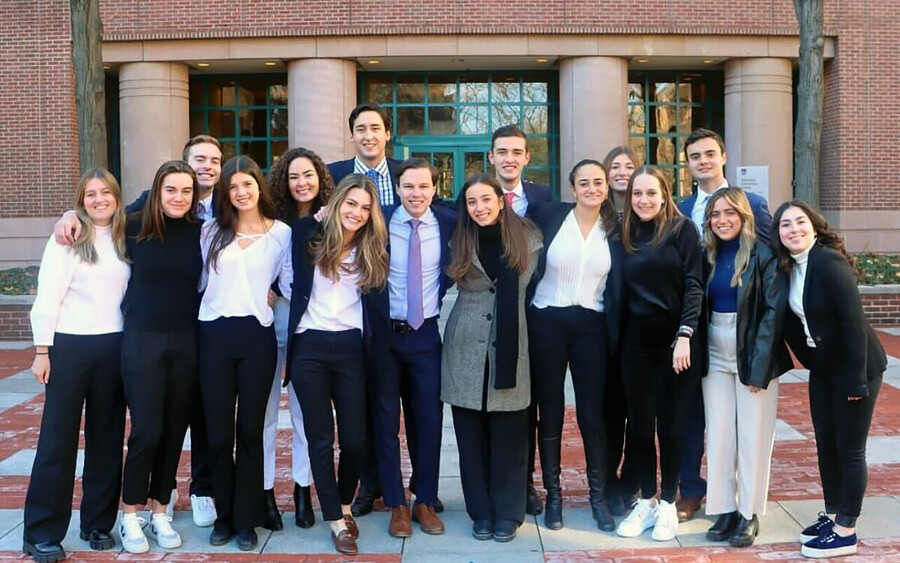 members of Wharton Latino outside a Wharton building on campus.