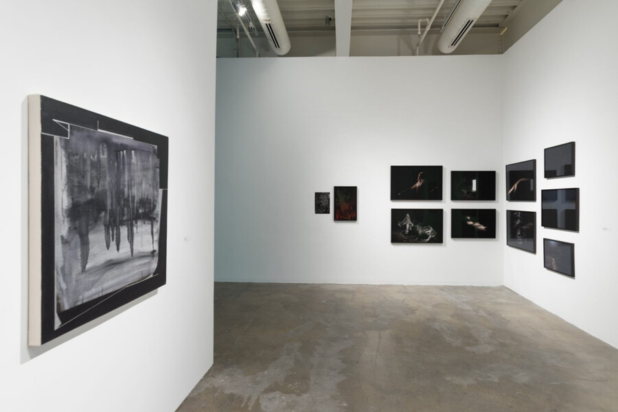 Pictures hanging on the wall at the “The Last Place They Thought Of” exhibit.