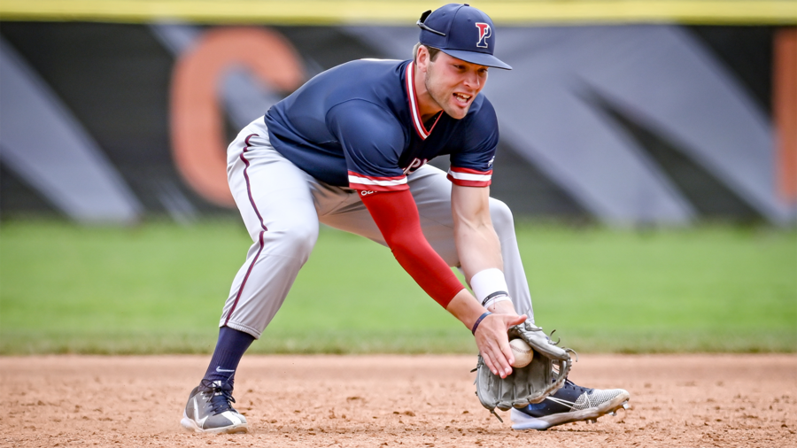 Wyatt Henseler fields a ball at third base during a game.