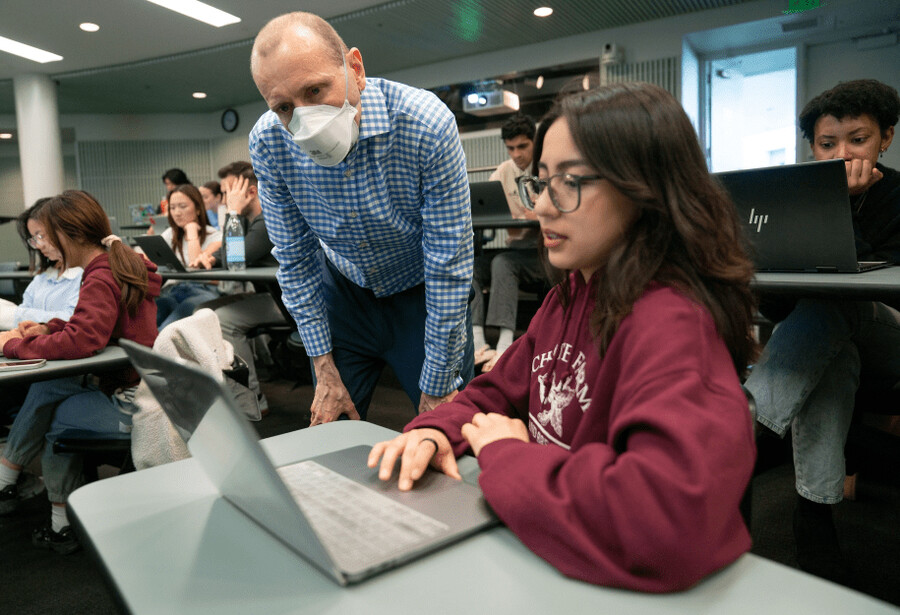 Matt O’Donnell helps communication major Nancy Miranda during class.