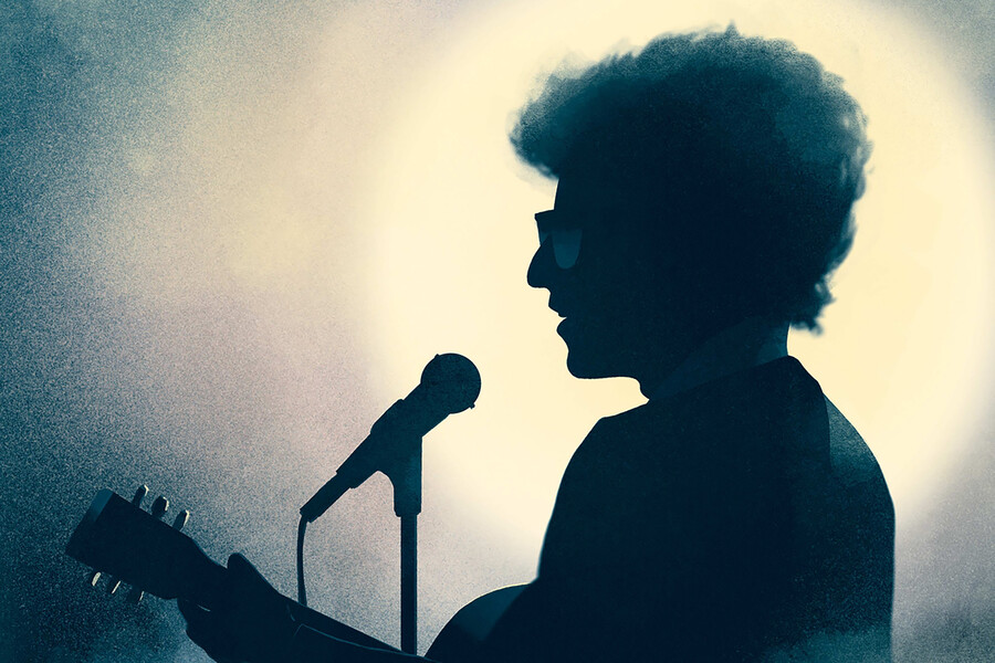 Bod Dylan in profile at a microphone.
