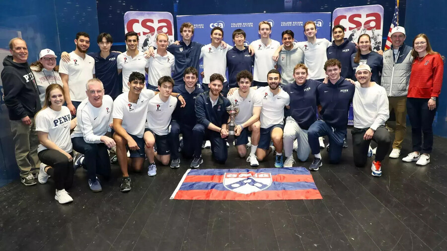 The Penn men’s squash team posing with a Potter Cup trophy.