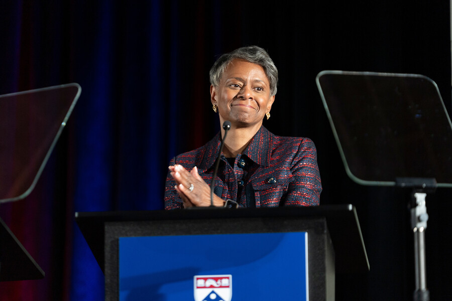 Vice President of Human Resources Felicia A. Washington speaking and clapping at the podium during the 2025 Models of Excellence ceremony.