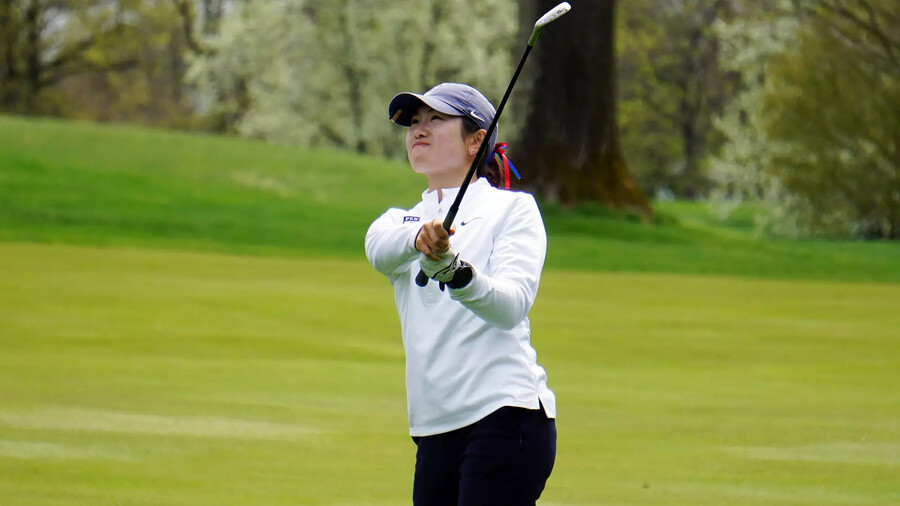 Julie Shin watches her ball after swinging during a match.