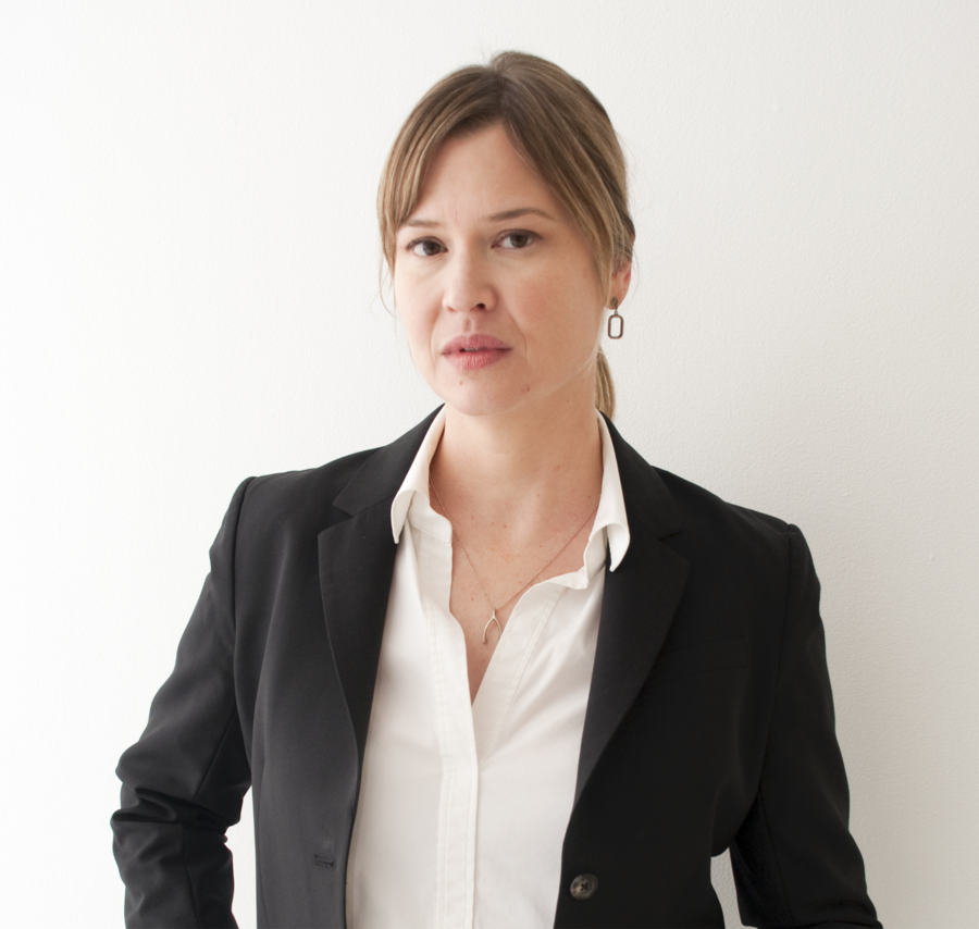 Portrait of a person in front of plain background.