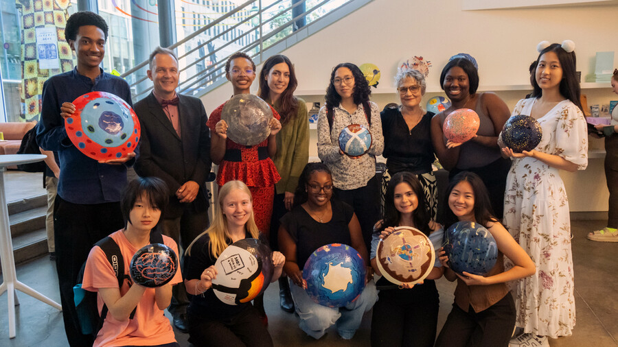 Students from Penn Medicine’s TRIP program hold up handmade decorative ceramics.
