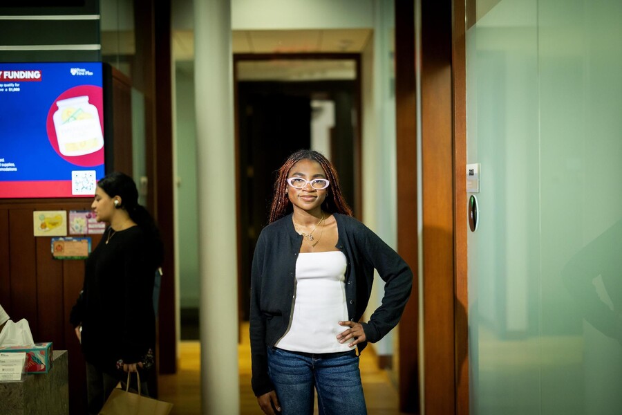 Mayokun Omitogun, a third-year neuroscience major on a pre-medicine track and an Africana Studies minor, standing and smiling in the Penn First Plus office