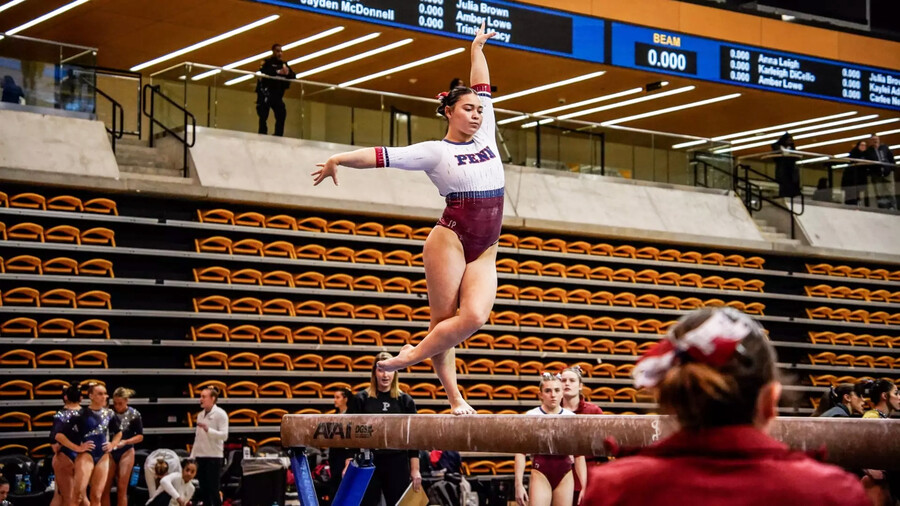 Carly Oniki performs on the balance beam during a competition.