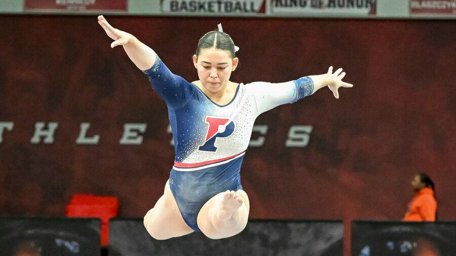 Carly Oniki jumps on the balance beam during a competition.