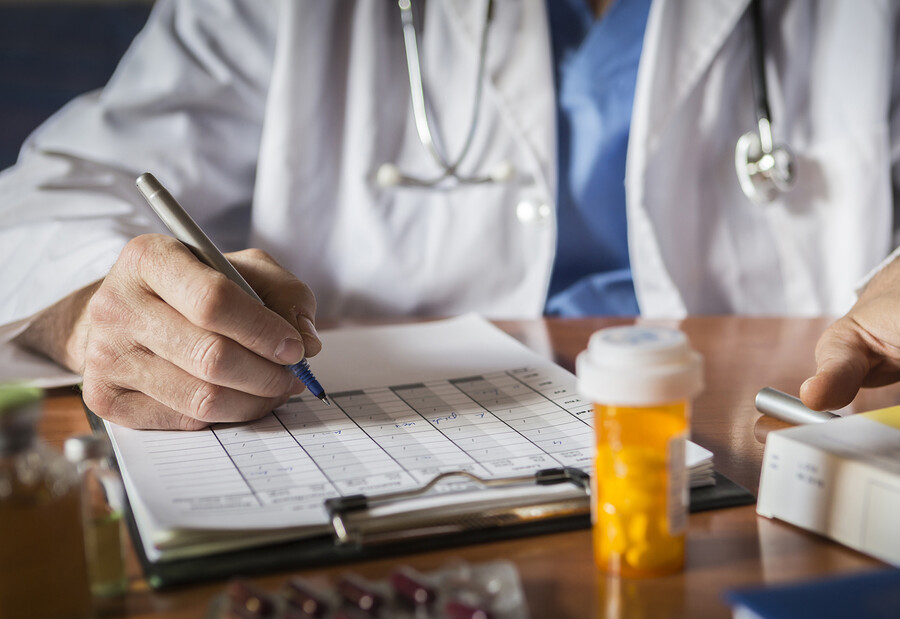 A doctor writing out a prescription.