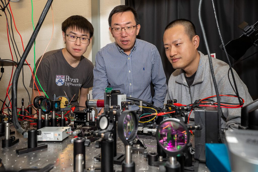 (From left) Xilin Feng, Liang Feng, and Tianwei Wu in an engineering lab.