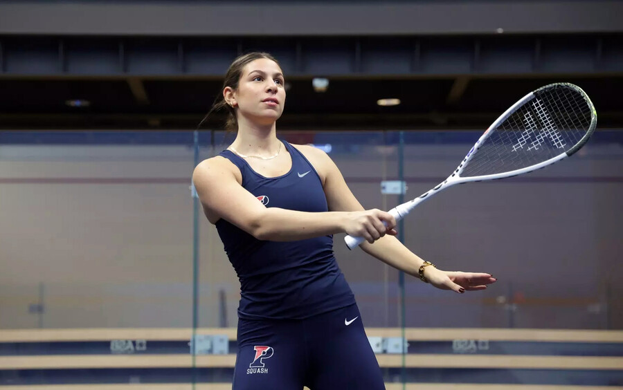 Jana Dweek watches the ball after swinging during a match at the Penn Squash Center.