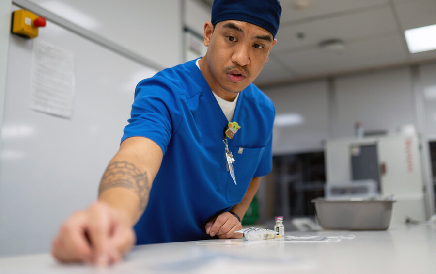 Pharmacy tech trainee Rodrigo Mateo double-checks a label in the inpatient pharmacy.