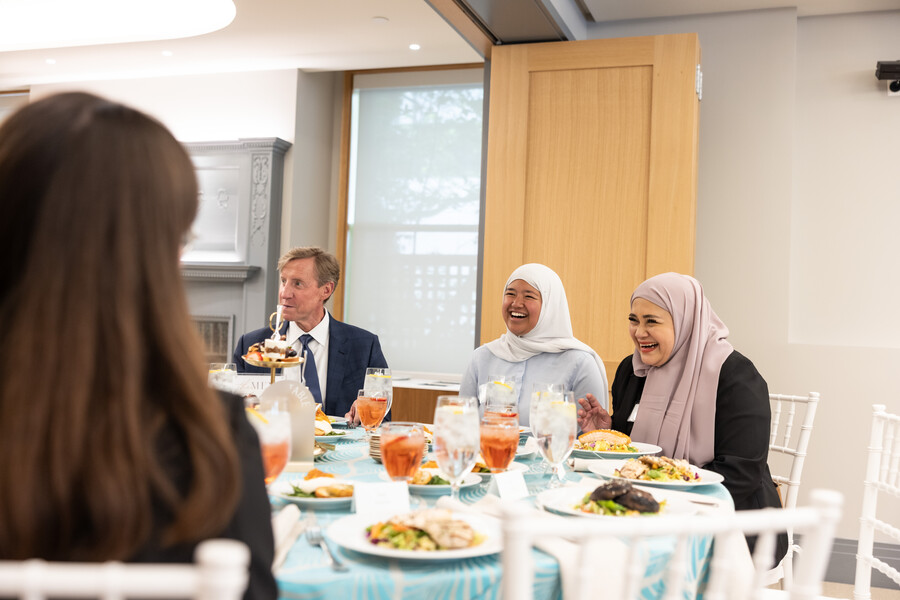 President J. Larry Jameson and Darlene Leohansson and her family member at a table at the PIP PEP luncheon.
