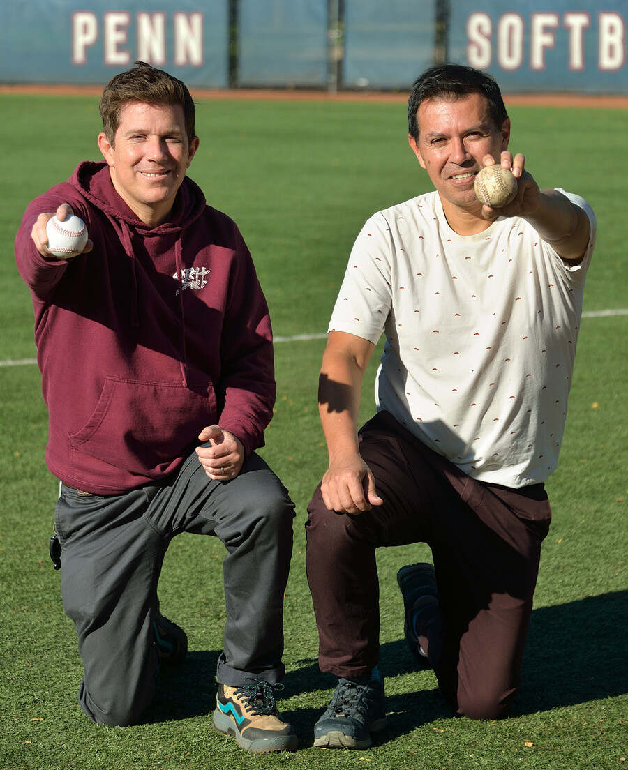 Douglas Jerolmack (left) and Paulo Arratia (right) holding baseballs on a field.