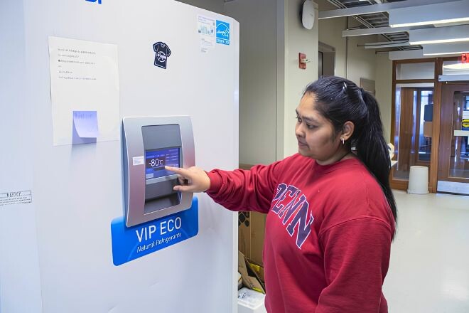 Srishti Jainapur recording the temperature on a freezer.