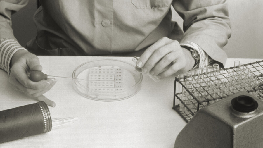 A lab tech with a pipette and petri dish during the Legionnaires disease outbreak of 1976.