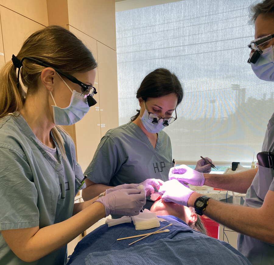 (From left): Joanna Walker, Stacy McMurray, and Chris Miller performing a skin cancer surgery.