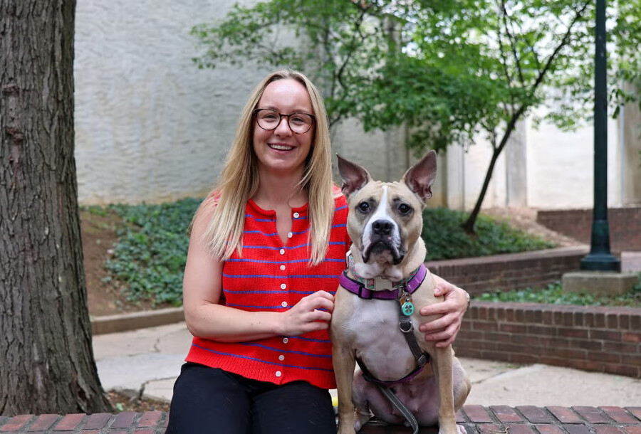 Lauren Powell with a dog outside Penn Vet.