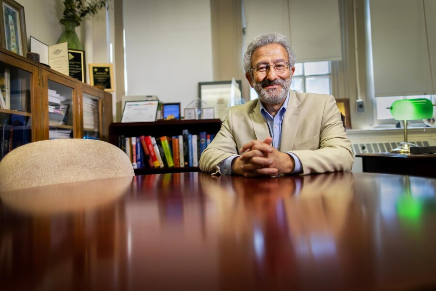 Nader Engheta seated at a desk in his office.