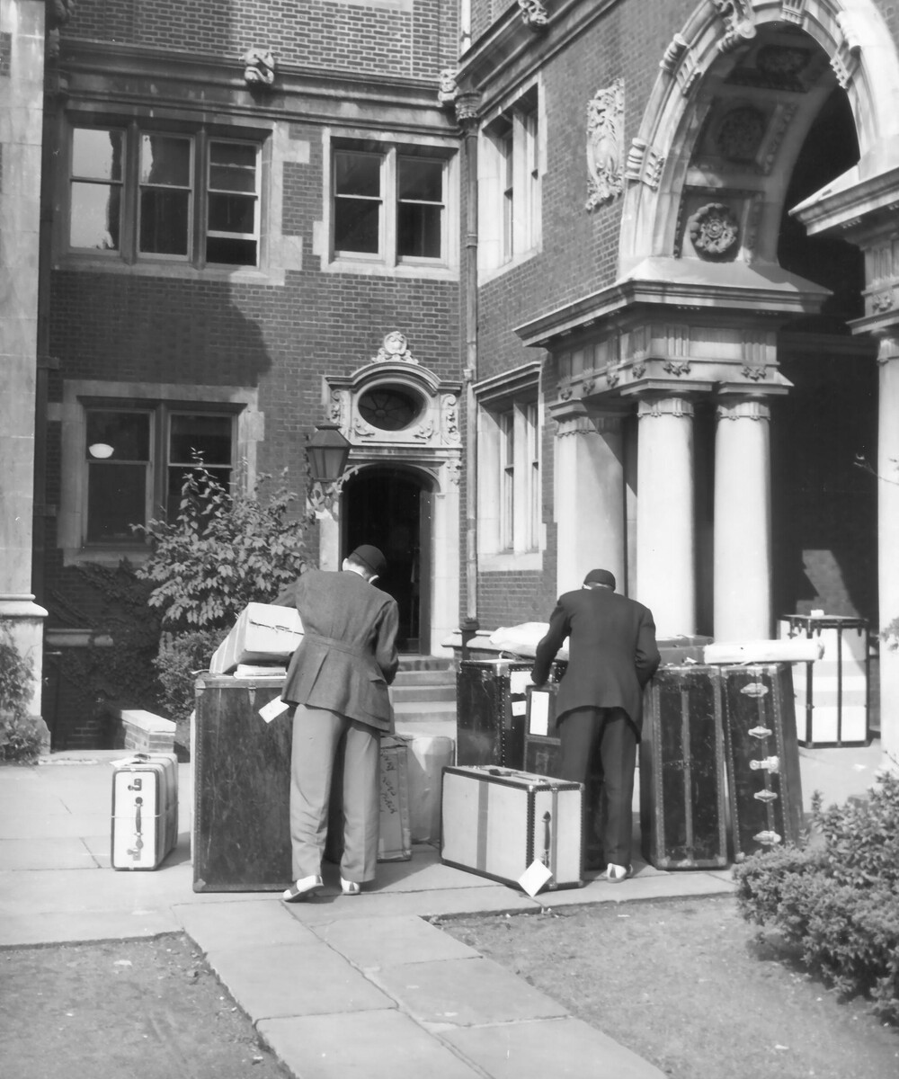 Two first-year students moving into the Upper Quad around 1940, wearing traditional beanie cap called “dinks.”