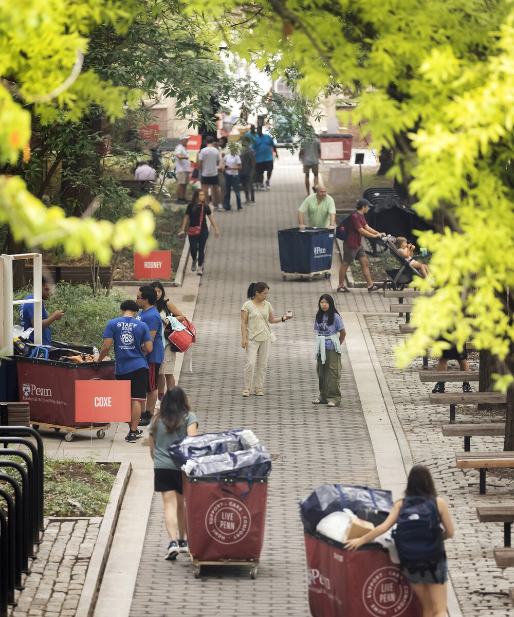 Students, families, and move-in carts on Locust Walk during Move-In.