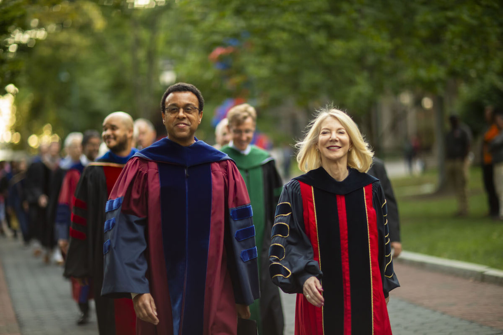 Penn Provost Wendell Pritchett and President Gutmann walk down Locust Walk at dusk.